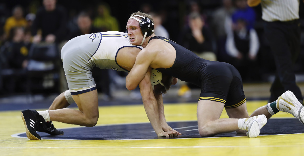 Iowa's Kaleb Young (right) scored a 16-6 decision over Chattanooga's George Carpenter.