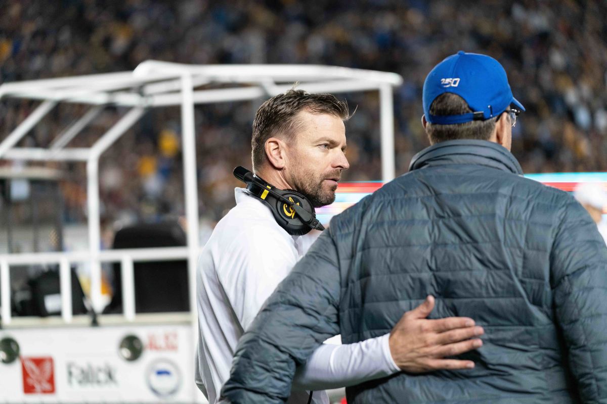 Cal coach Justin Wilcox comforts Evan Tattersall's father
