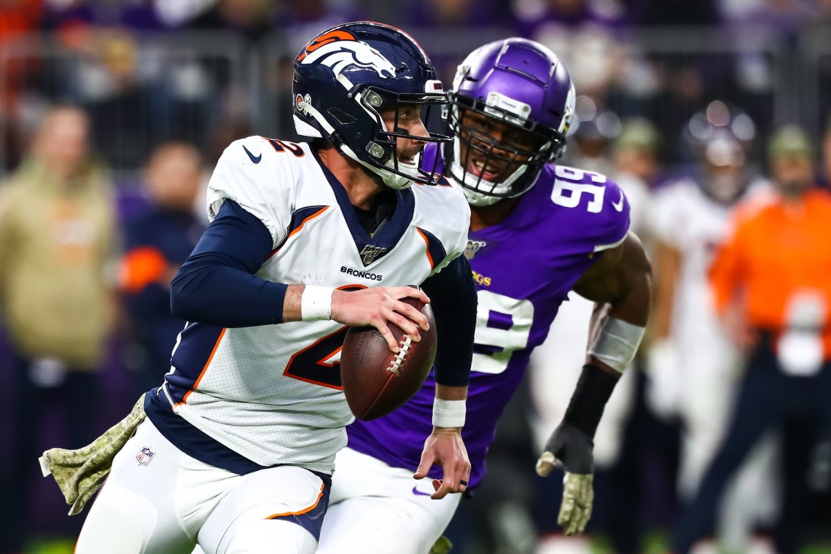 Denver Broncos quarterback Brandon Allen (2) is flushed out of the pocket by Minnesota Vikings defensive end Danielle Hunter (99) in the third quarter at U.S. Bank Stadium.