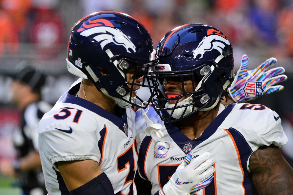 Denver Broncos linebacker Todd Davis (51) celebrates with free safety Justin Simmons (31) after returning an interception for a touchdown during the first half against the Arizona Cardinals at State Farm Stadium.