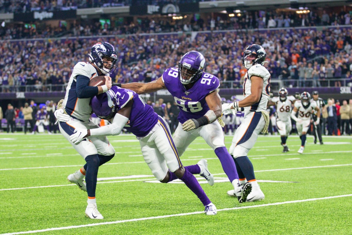 Minnesota Vikings defensive back Jayron Kearse (27) tackles Denver Broncos quarterback Brandon Allen (2) during the fourth quarter at U.S. Bank Stadium.