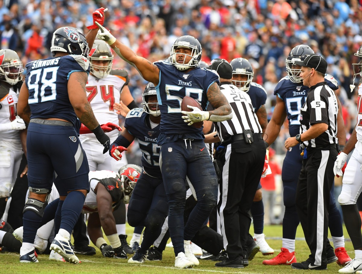 Tennessee Titans linebacker Harold Landry (58) celebrates after forcing and recovering a fumble during the second half against the Tampa Bay Buccaneers at Nissan Stadium.