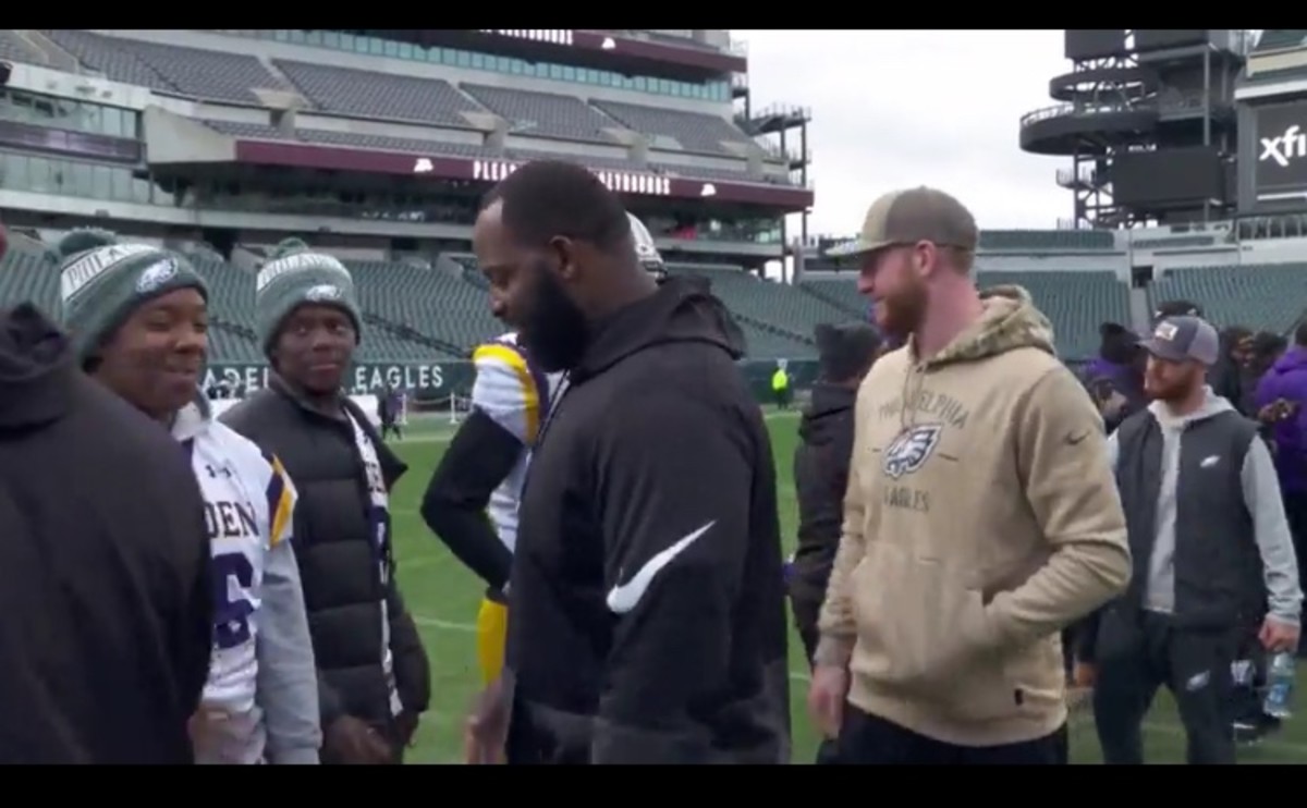 Fletcher Cox (left) and Carson Wentz were several Eagles who went to Lincoln Financial Field to greet the two high school teams playing there on Wednesday that were affected by a shooting on Friday night.