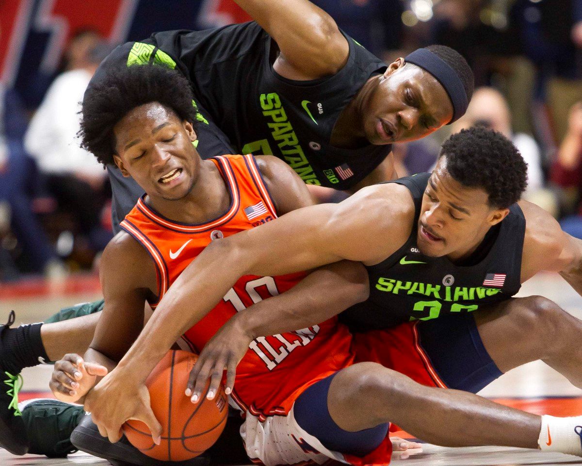 Illinois guard Andres Feliz (10) and Michigan State forward Xavier Tillman (23) compete for a loose ball during the second half at State Farm Center.
