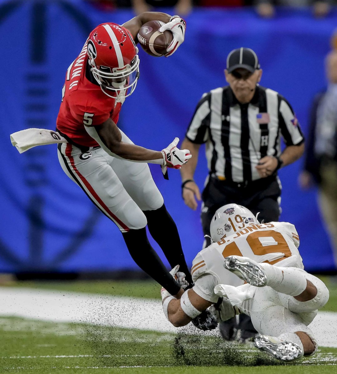 Jan 1, 2019; New Orleans, LA, USA; Georgia Bulldogs wide receiver Terry Godwin (5) is tackled by Texas Longhorns defensive back Brandon Jones (19) during the first quarter in the 2019 Sugar Bowl at Mercedes-Benz Superdome. Mandatory Credit: Derick E. Hingle-USA TODAY Sports