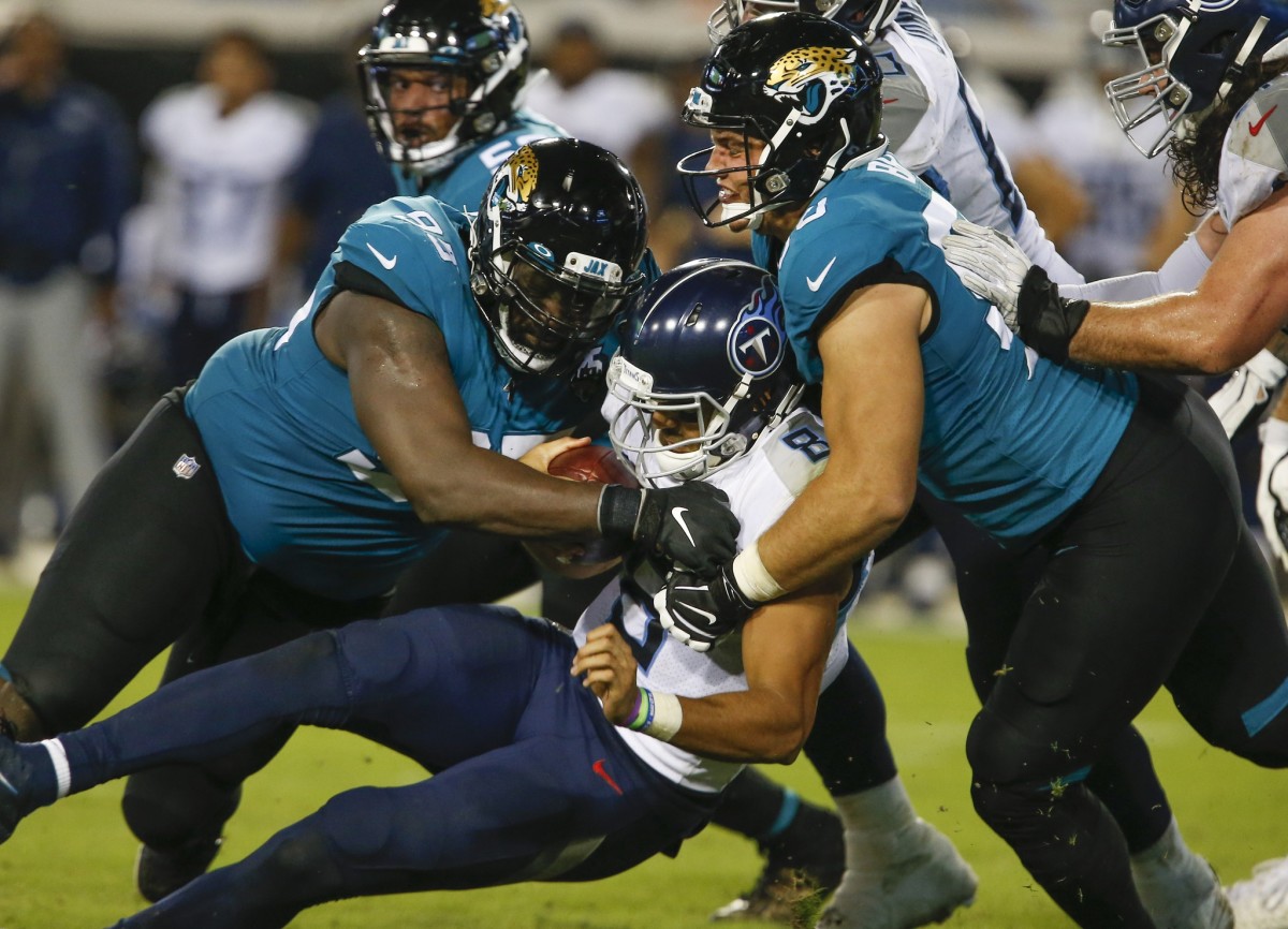 Jacksonville Jaguars defensive tackles Abry Jones (left) and Taven Bryan (right) combine to sack Tennessee Titans quarterback Marcus Mariota (middle) during the second half at TIAA Bank Field.