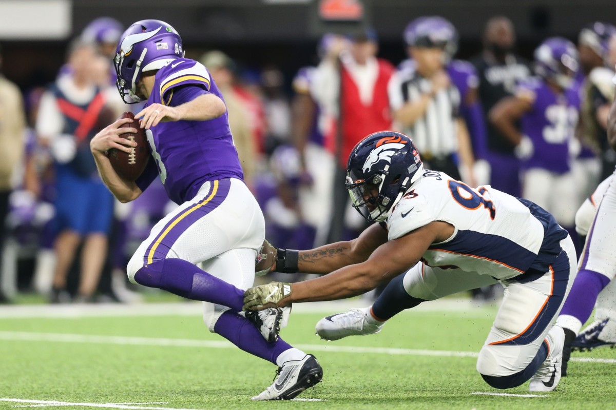 Denver Broncos defensive end Dre'Mont Jones (93) sacks Minnesota Vikings quarterback Kirk Cousins (8) during the third quarter at U.S. Bank Stadium.