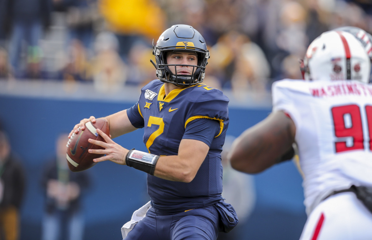 West Virginia Mountaineers quarterback Jarret Doege (2) throws a pass during the third quarter against the Texas Tech Red Raiders at Mountaineer Field at Milan Puskar Stadium.