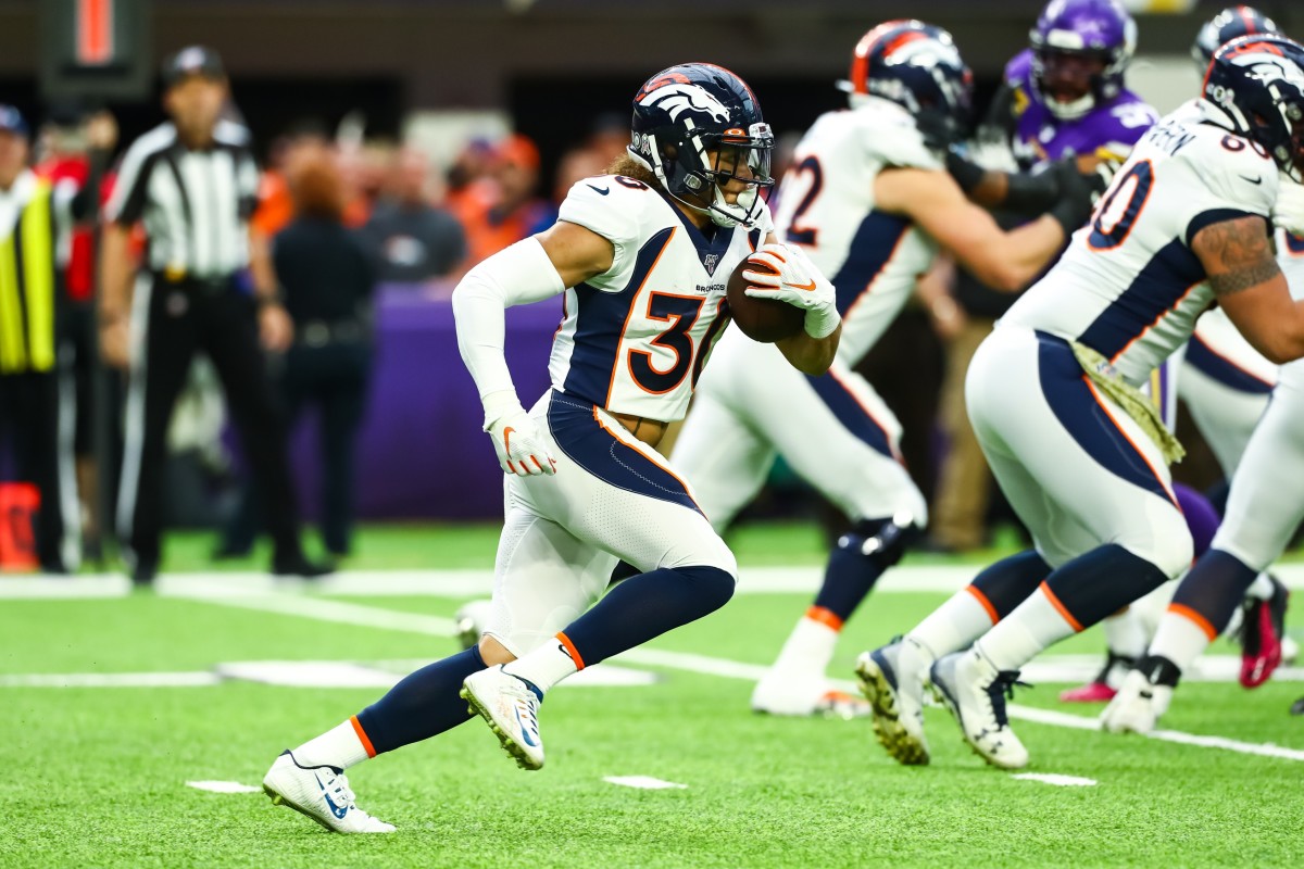Denver Broncos running back Phillip Lindsay (30) runs with the ball against the Minnesota Vikings in the first quarter at U.S. Bank Stadium.