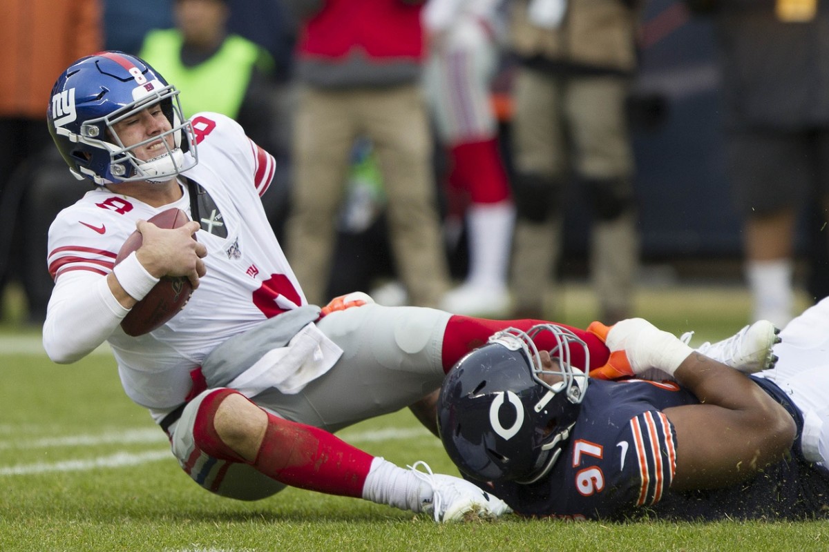Nov 24, 2019; Chicago, IL, USA; New York Giants quarterback Daniel Jones (8) is sacked by Chicago Bears defensive tackle Nick Williams (97) in the third quarter at Soldier Field.