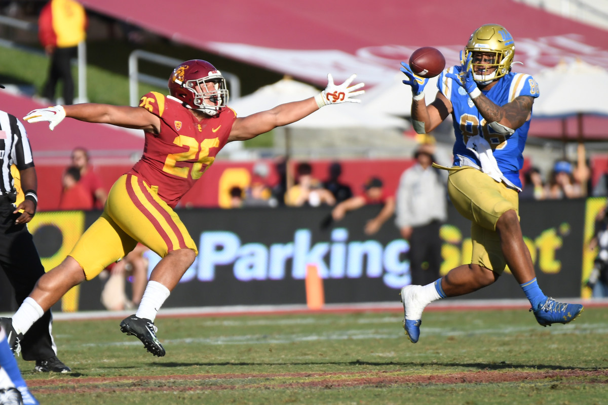 UCLA tight end Devin Asiasi hauls in a pass against USC.