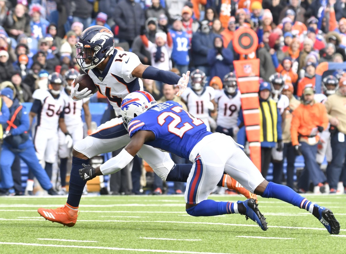 Denver Broncos wide receiver Courtland Sutton (14) runs after a catch as Buffalo Bills cornerback Tre'Davious White (27) makes the tackle in the first quarter at New Era Field.