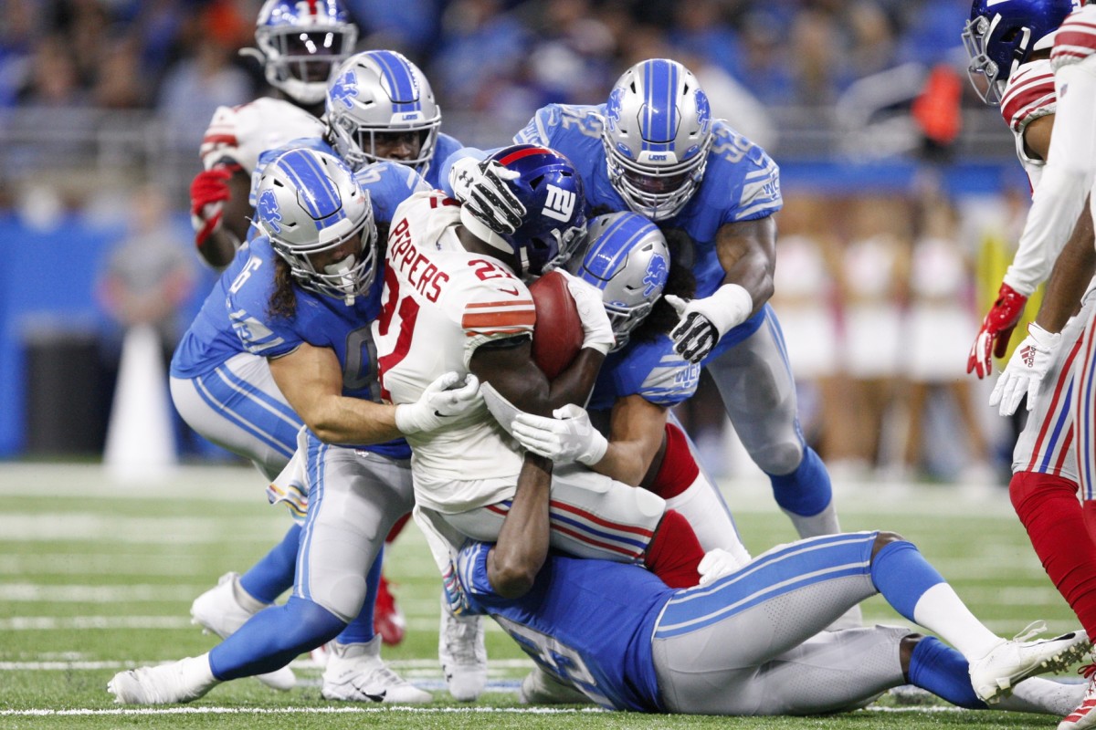 Oct 27, 2019; Detroit, MI, USA; New York Giants free safety Jabrill Peppers (21) gets tackled by a group of players including Detroit Lions running back Nick Bawden (46) outside linebacker Christian Jones (52) and defensive back C.J. Moore (49) during the fourth quarter at Ford Field.