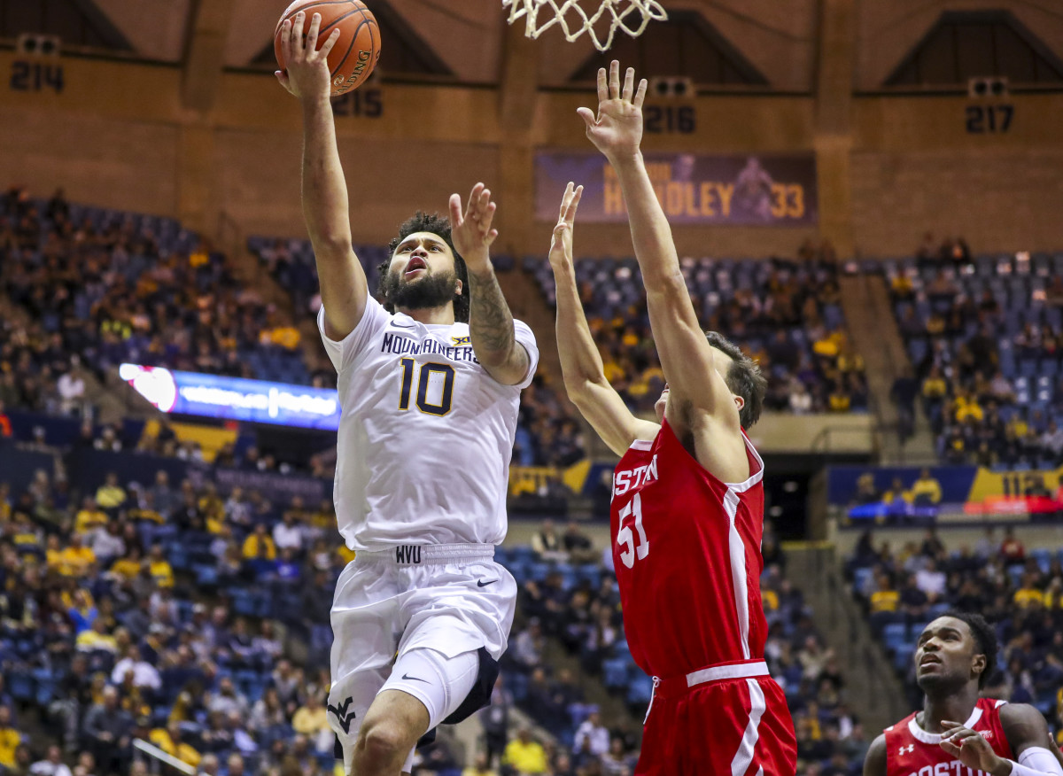 West Virginia Mountaineers guard Jermaine Haley (10) shoots while guarded by Boston University Terriers forward Max Mahoney (51) during the second half at WVU Coliseum.