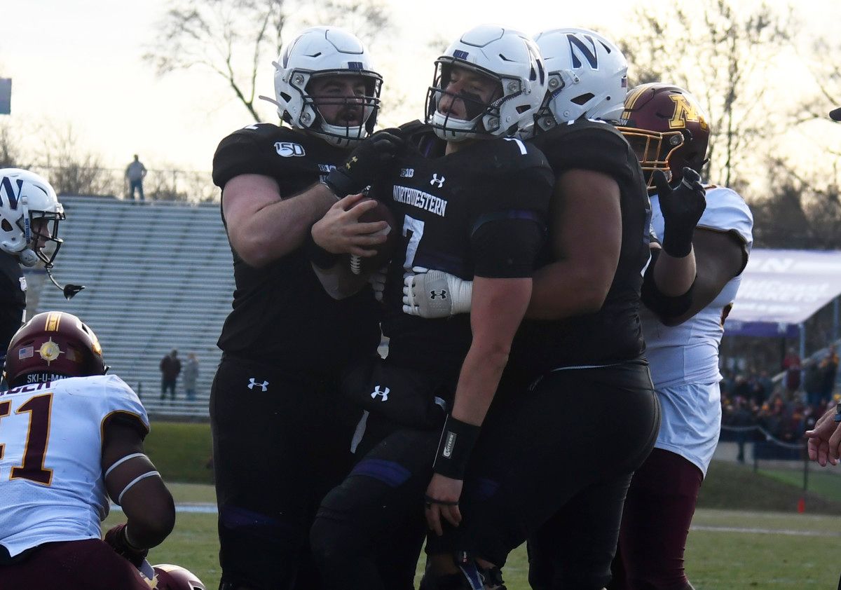Northwestern quarterback Andrew Marty (7) celebrates his touchdown against Minnesota during the second half at Ryan Field.