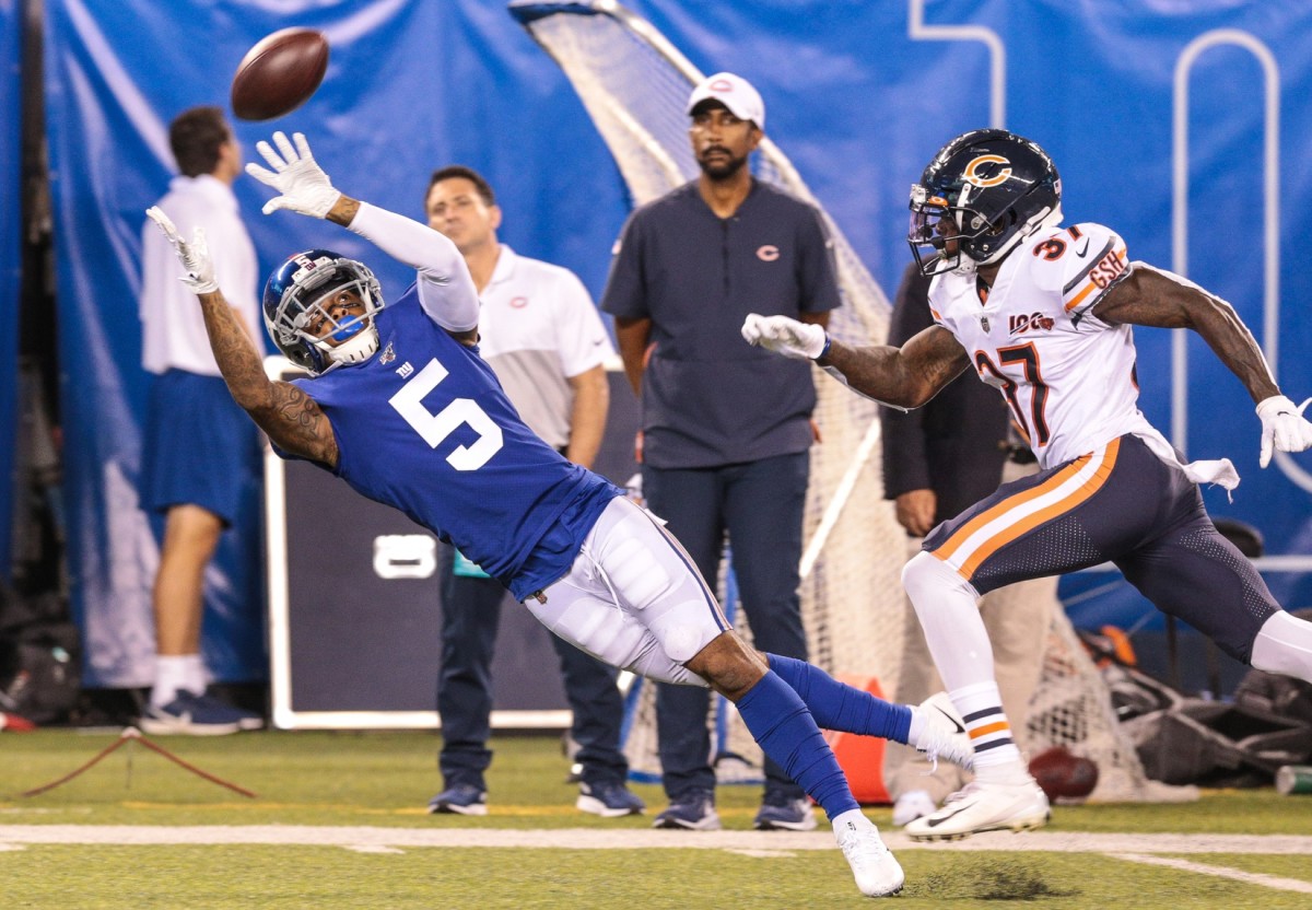 Aug 16, 2019; East Rutherford, NJ, USA; New York Giants wide receiver Da'Mari Scott (5) catches a pass as Chicago Bears defensive back John Franklin (37) defends during the second half at MetLife Stadium.