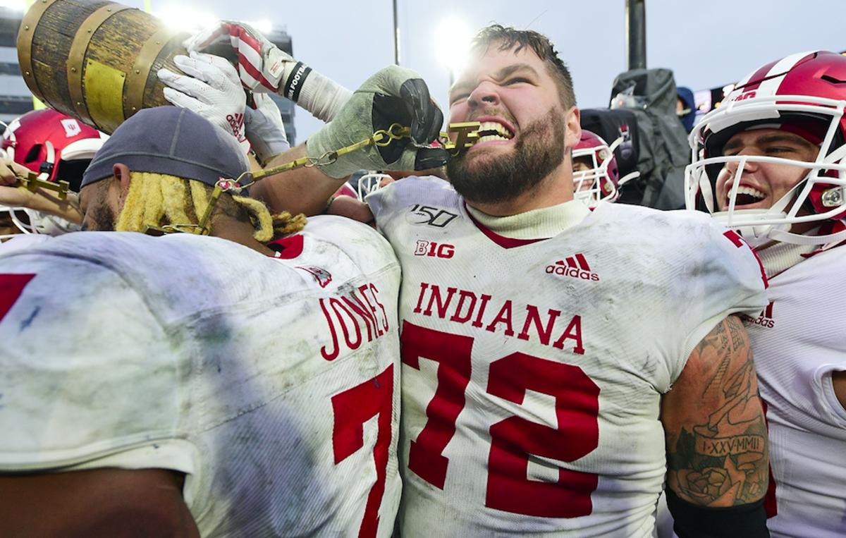 West Lafayette, IN, USA; Indiana Hoosiers offensive lineman Simon Stepaniak (72) bites one of the letters from the Old Oaken Bucket after the Hoosiers defeated the Purdue Boilermakers, 44-41, in 2 OT at Ross-Ade Stadium. Mandatory Credit: Thomas J. Russo-USA TODAY Sports