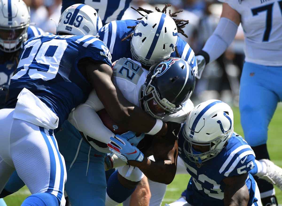 Tennessee Titans running back Derrick Henry (22) is stopped for a loss against the Indianapolis Colts during the first half at Nissan Stadium.