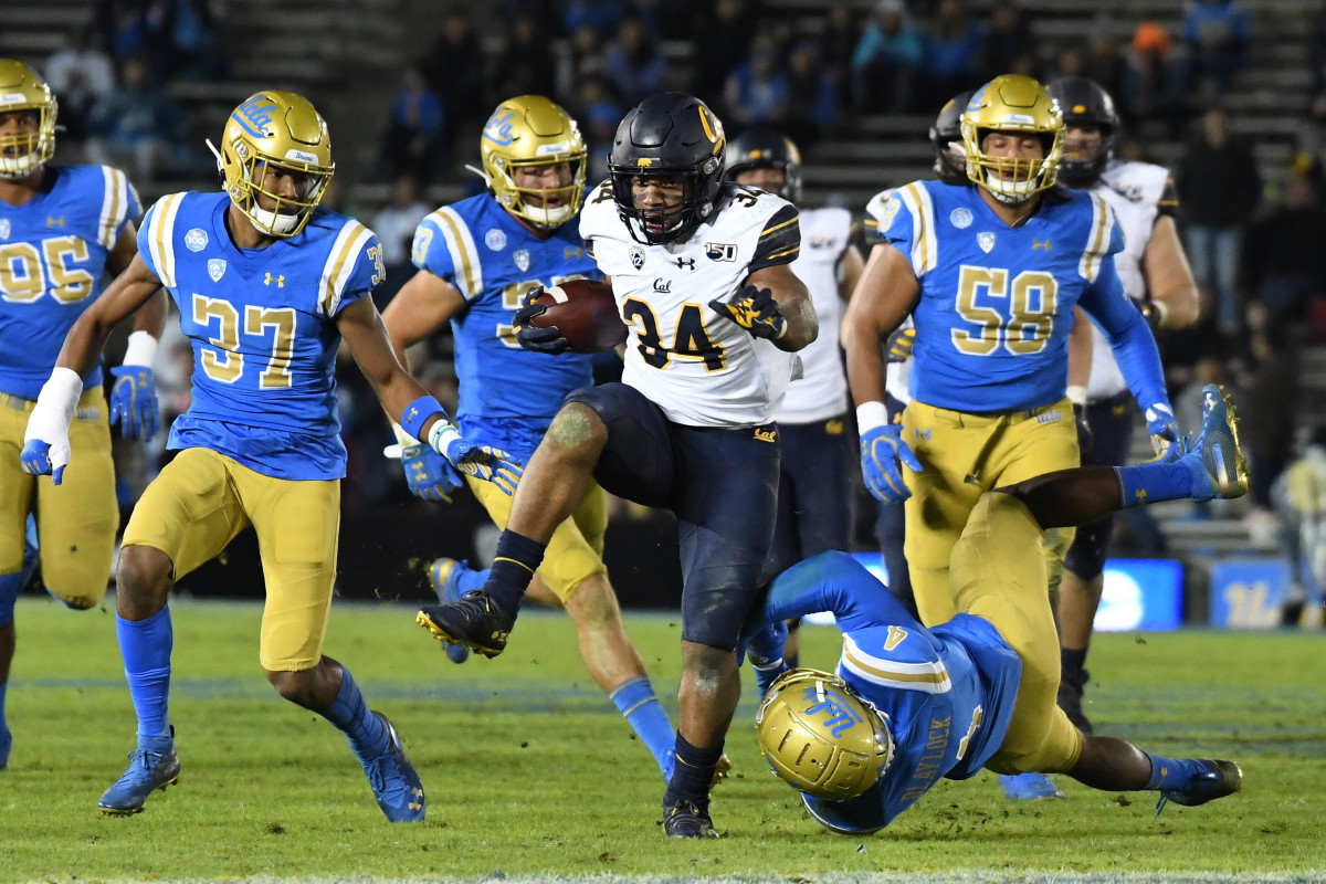 Cal running back Christopher Brown Jr. dashes away from a UCLA would-be tackler.