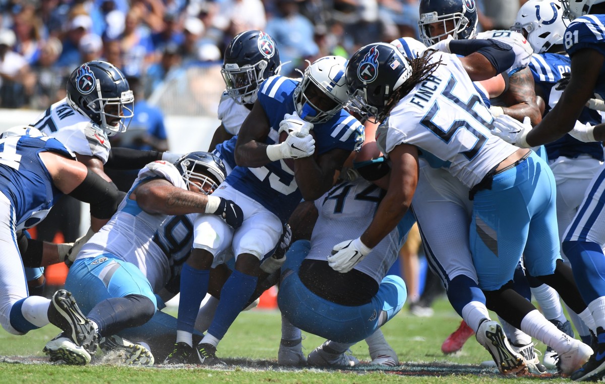 Indianapolis Colts running back Marlon Mack (25) is stopped by a group of Tennessee Titans defenders during the first half at Nissan Stadium.