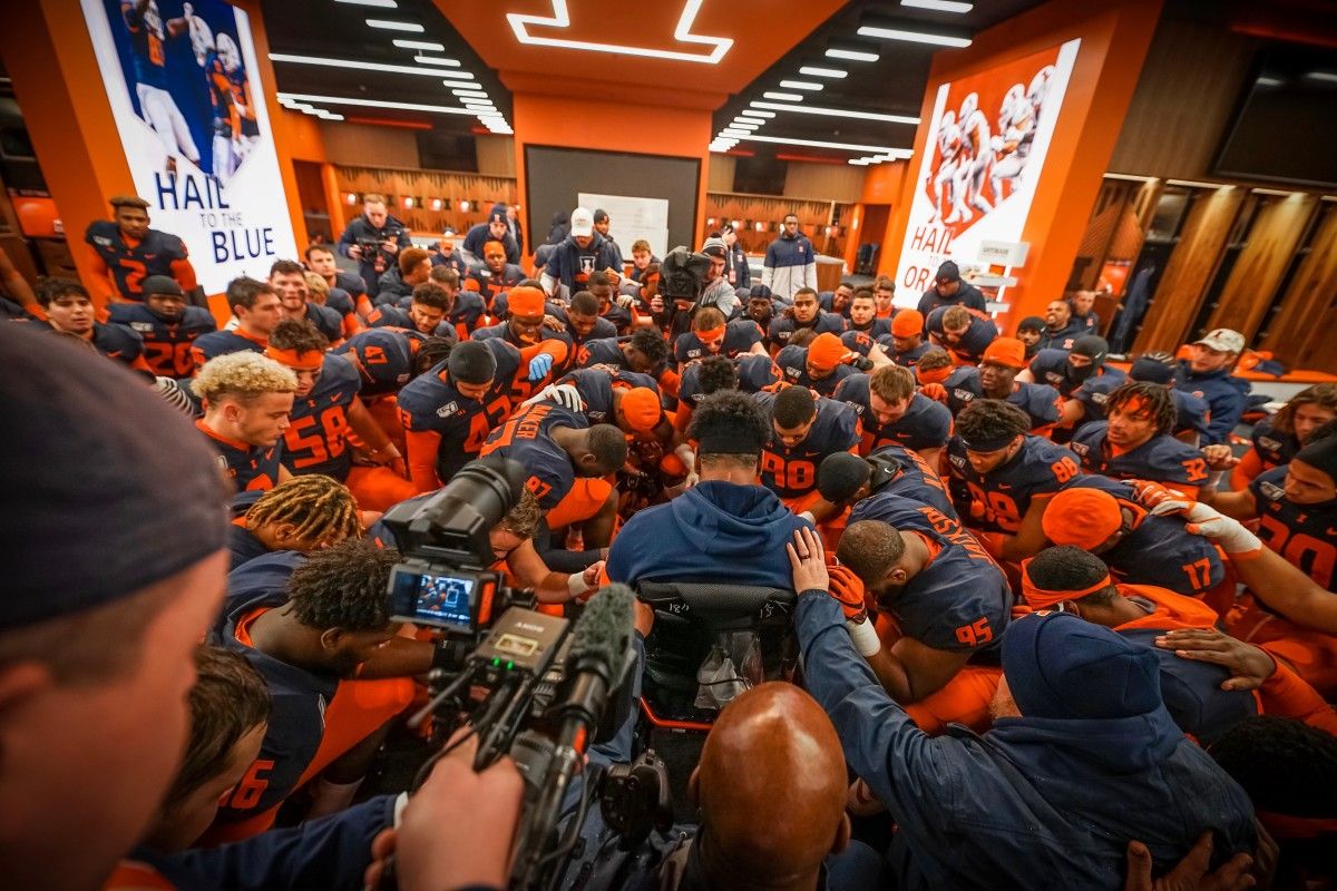 Illinois players gathering around Bobby Roundtree in the pre-game prayer before Saturday's rivalry game against Northwestern.