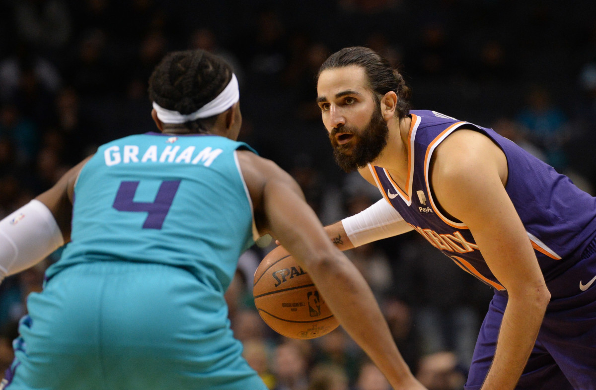 Dec 2, 2019; Charlotte, NC, USA; Phoenix Suns guard Ricky Rubio (right) dribbles against Charlotte Hornets guard Devonte' Graham (4) during the second half at the Spectrum Center. The Suns won 109-104. (Sam Sharpe-USA TODAY Sports)