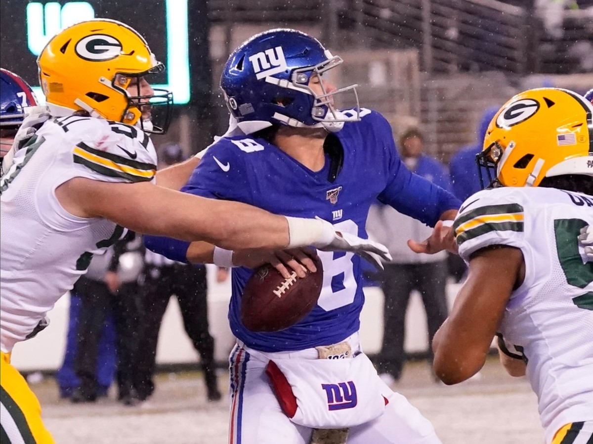 Dec 1, 2019; East Rutherford, NJ, USA; New York Giants quarterback Daniel Jones (8) under pressure from the Packers in the fourth quarter at MetLife Stadium.