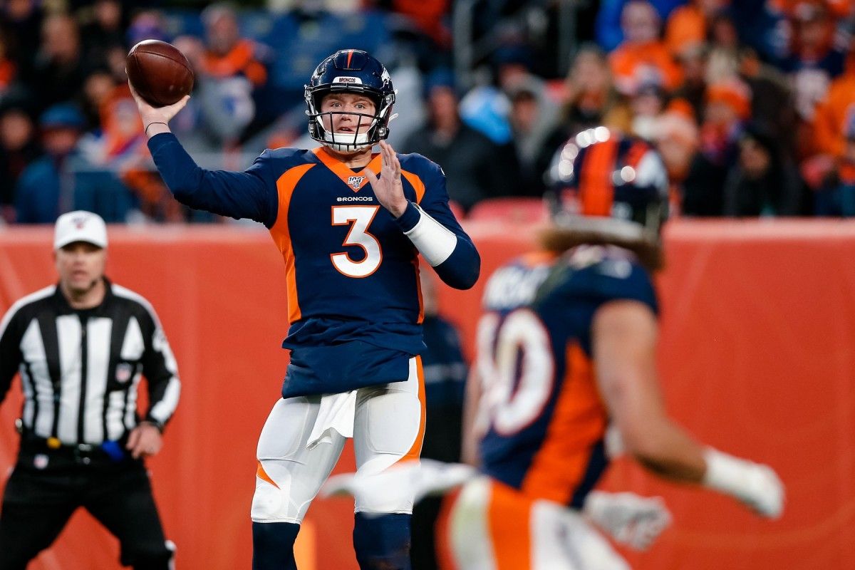 Denver Broncos quarterback Drew Lock (3) looks to pass to running back Phillip Lindsay (30) in the third quarter against the Los Angeles Chargers at Empower Field at Mile High.