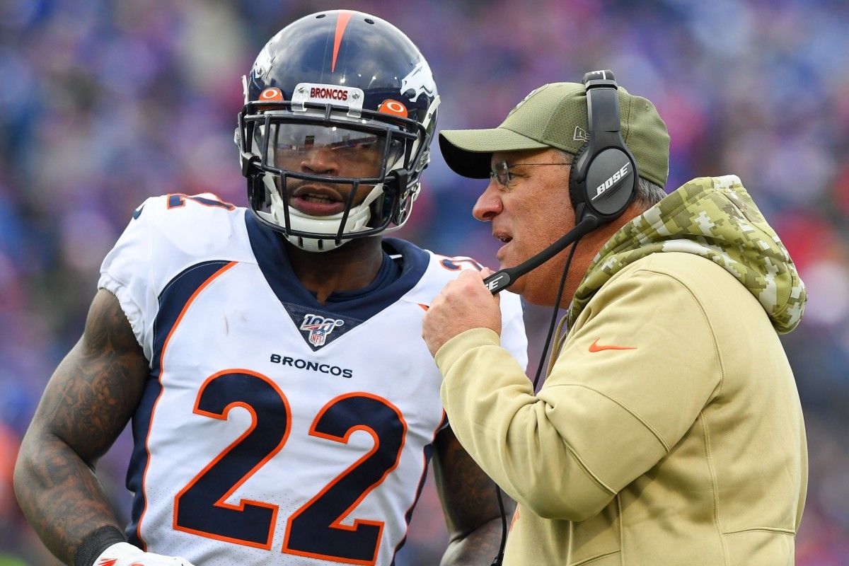 Denver Broncos head coach Vic Fangio talks with strong safety Kareem Jackson (22) during a time-out against the Buffalo Bills during the second quarter at New Era Field.