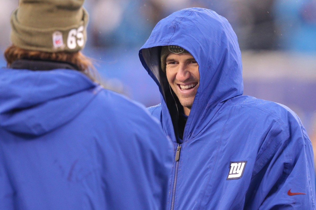 Dec 1, 2019; East Rutherford, NJ, USA; New York Giants quarterback Eli Manning (10) laughs as he talks to guard Nick Gates (65) on the sidelines during the third quarter against the Green Bay Packers at MetLife Stadium.