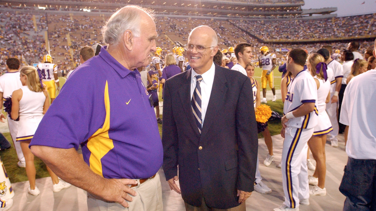 In a photo believed to be from the early 2000s, Sam Nader speaks on the sideline with former LSU president William Jenkins.