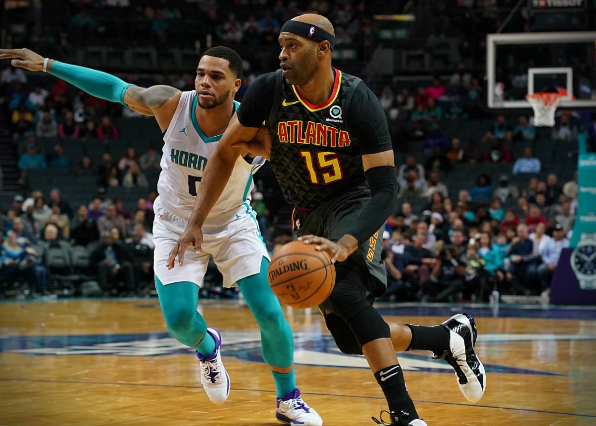 Dec 8, 2019; Charlotte, NC, USA; Atlanta Hawks guard Vince Carter (15) dribbles to the basket covered by Charlotte Hornets forward Miles Bridges (0) in the first half at Spectrum Center. Mandatory Credit: Jim Dedmon-USA TODAY Sports