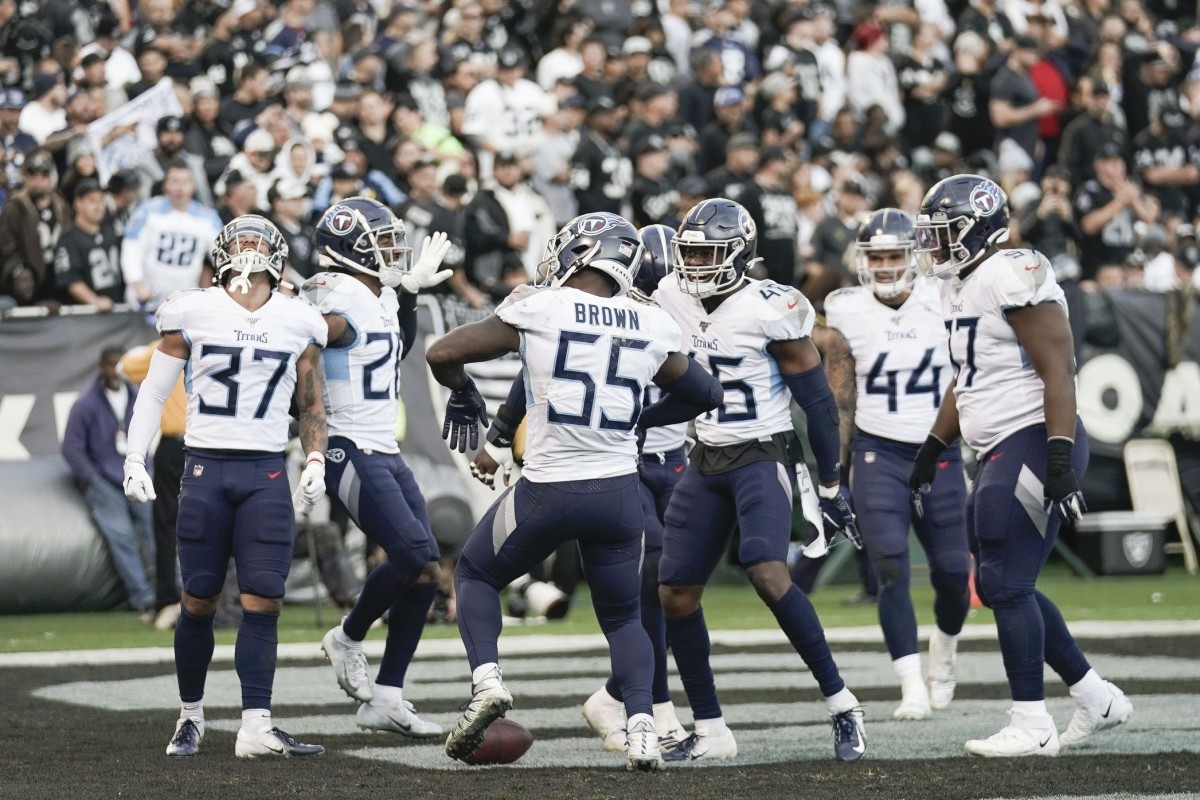 ennessee Titans inside linebacker Jayon Brown (55) celebrates with teammates after scoring a touchdown against the Oakland Raiders during the fourth quarter at Oakland Coliseum.