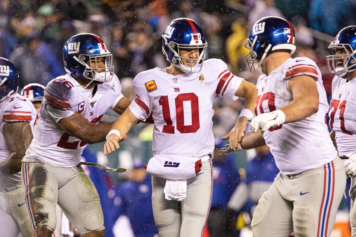Dec 9, 2019; Philadelphia, PA, USA; New York Giants quarterback Eli Manning (10) celebrates with running back Saquon Barkley (26) and offensive guard Kevin Zeitler (70) after his second touchdown pass of the game during the second quarter against the Philadelphia Eagles at Lincoln Financial Field.