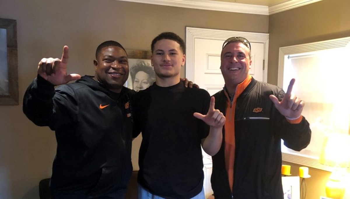Mason Cobb, in the middle, visited by Oklahoma State coaches Tim Duffie and Dan Hammerschmidt.