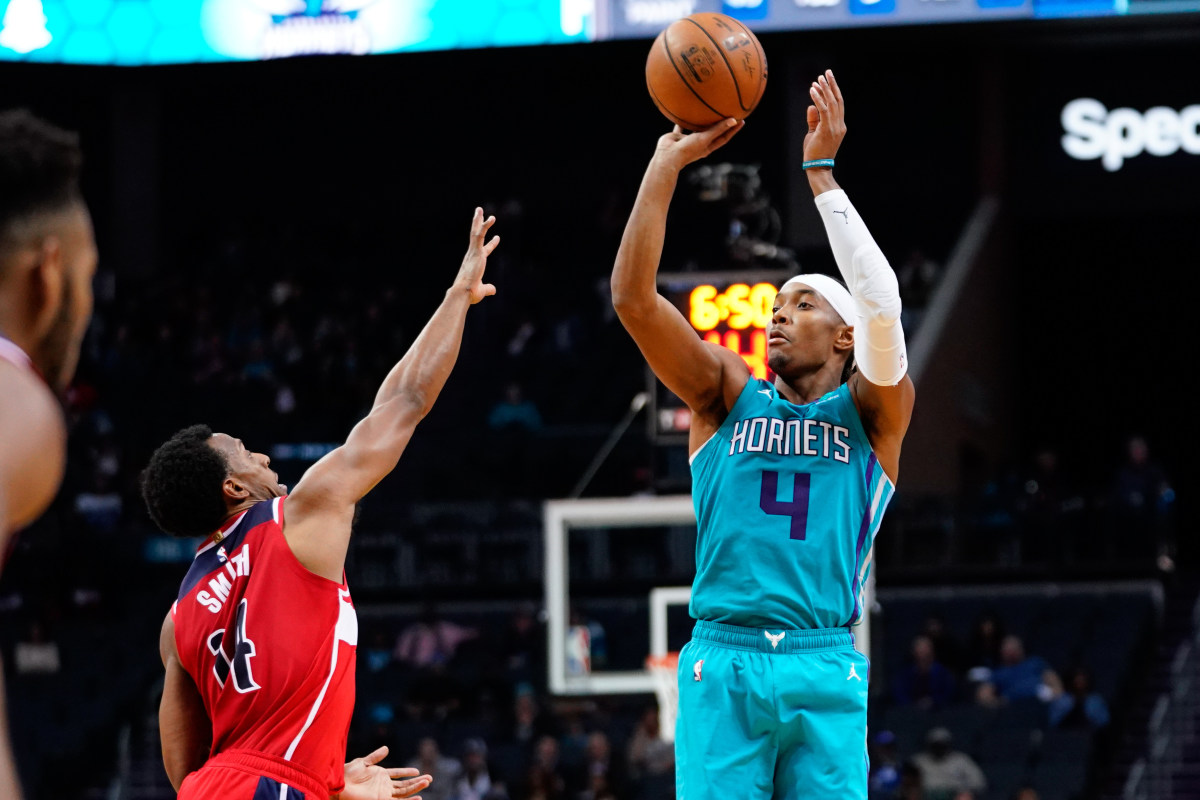 Dec. 10, 2019; Charlotte, NC, USA; Charlotte Hornets guard Devonte' Graham (4) shoots a three point basket against Washington Wizards guard Ish Smith (14) during the second half at Spectrum Center. (Jeremy Brevard-USA TODAY Sports)