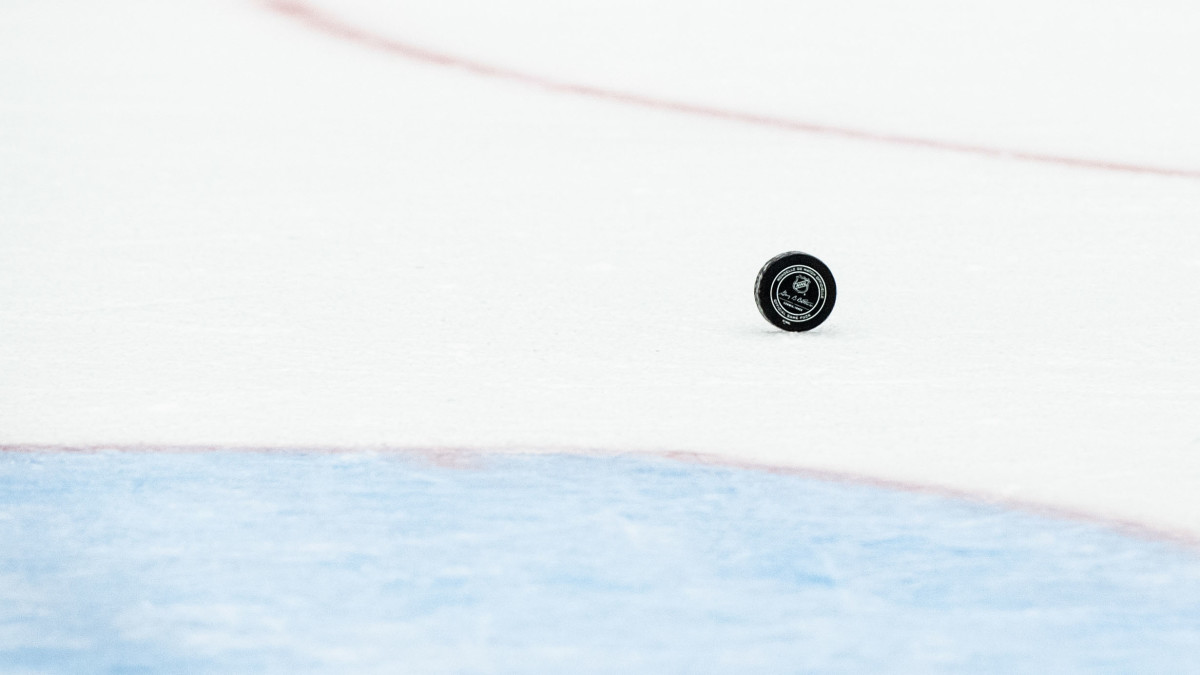 An NHL hockey puck rolling on the ice