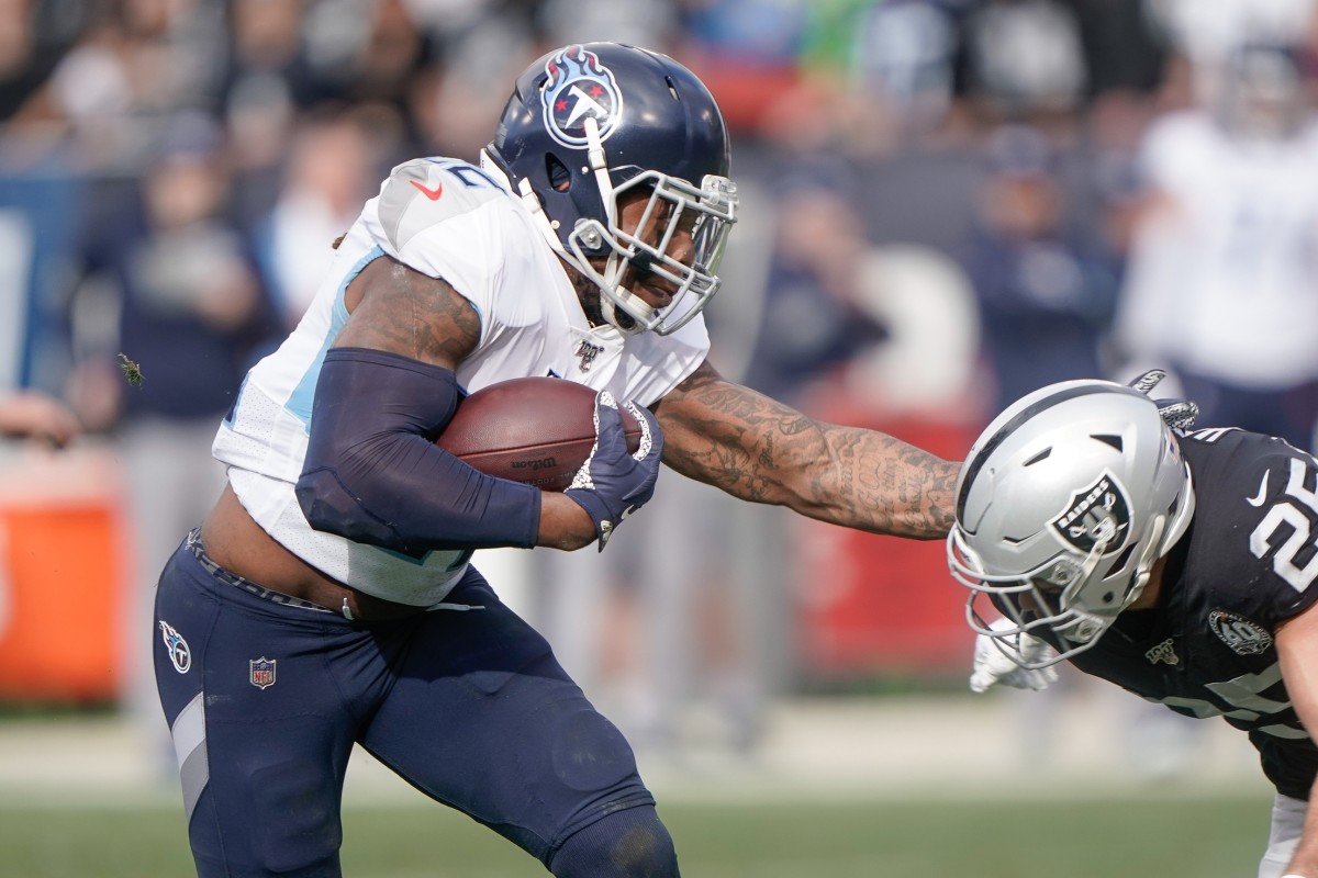 Tennessee Titans running back Derrick Henry (22) carries the ball against Oakland Raiders free safety Erik Harris (25) during the first quarter at Oakland Coliseum.