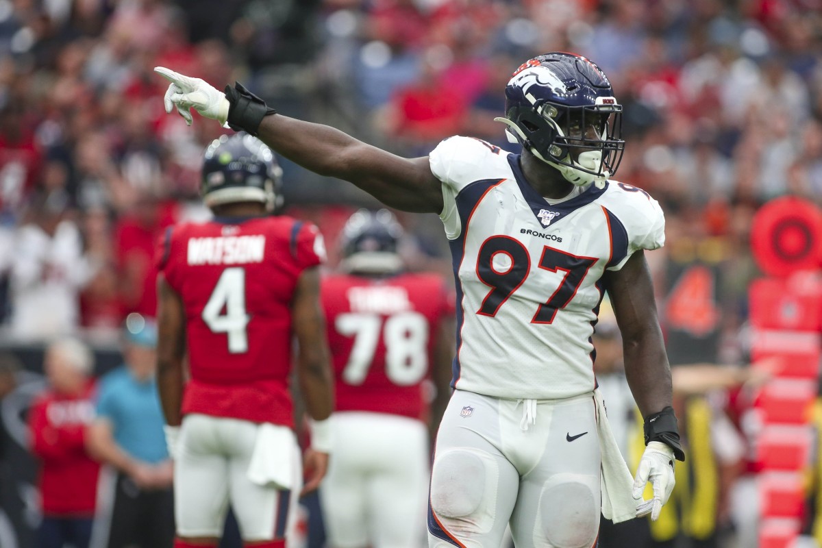 Denver Broncos linebacker Jeremiah Attaochu (97) signals first down after a turnover on downs by the Houston Texans during the second quarter at NRG Stadium.