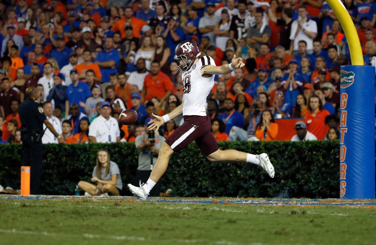 Texas A&M Aggies punter Shane Tripucka (18) punts the ball against the Florida Gators during the first half at Ben Hill Griffin Stadium.