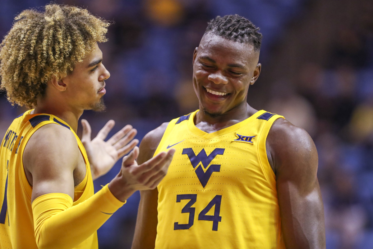 West Virginia Mountaineers forward Emmitt Matthews Jr. (11) and West Virginia Mountaineers forward Oscar Tshiebwe (34) talk late in the second half against the Austin Peay Governors at WVU Coliseum.