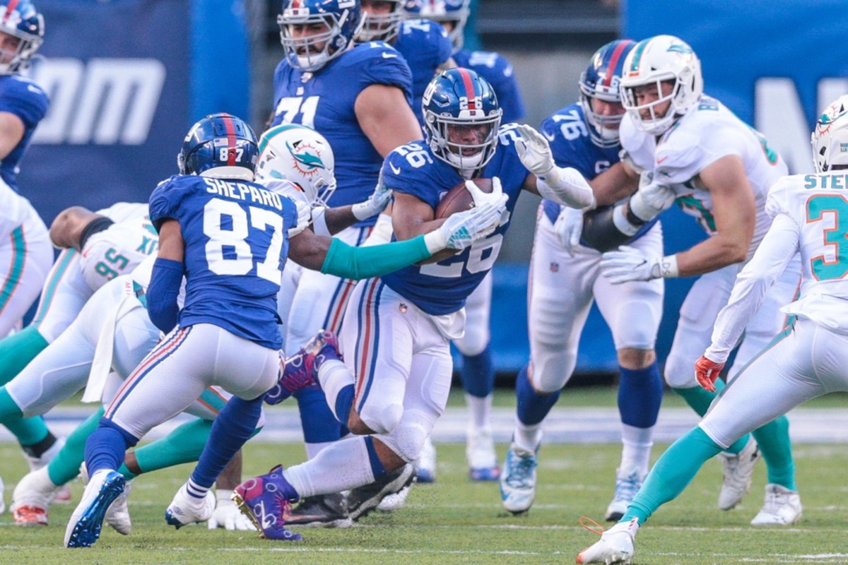 Dec 15, 2019; East Rutherford, NJ, USA; New York Giants running back Saquon Barkley (26) carries the ball against the Miami Dolphins during the first half at MetLife Stadium.