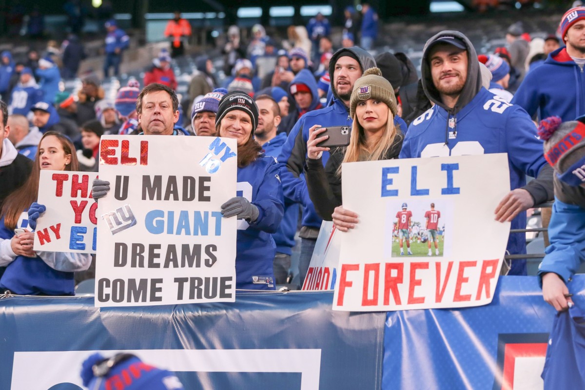 Dec 15, 2019; East Rutherford, NJ, USA; New York Giants fans hold signs honoring New York Giants quarterback Eli Manning, not picture, after the game between the New York Giants and the Miami Dolphins at MetLife Stadium.