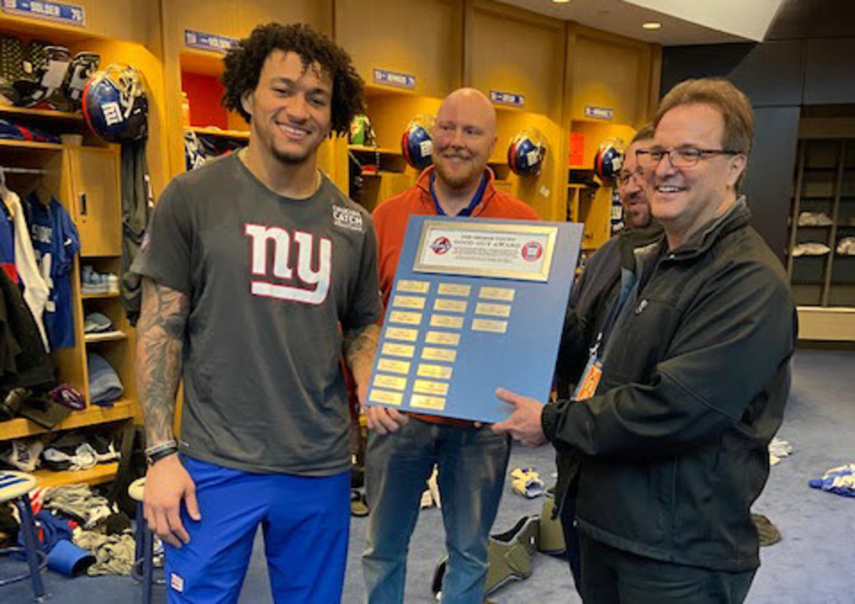 Dec. 18, 2019 - Tight end Evan Engram accepts the annual George Young Good Guy award from PFWA President Bob Glauber (right) and Giants chapter president Tom Rock (center).