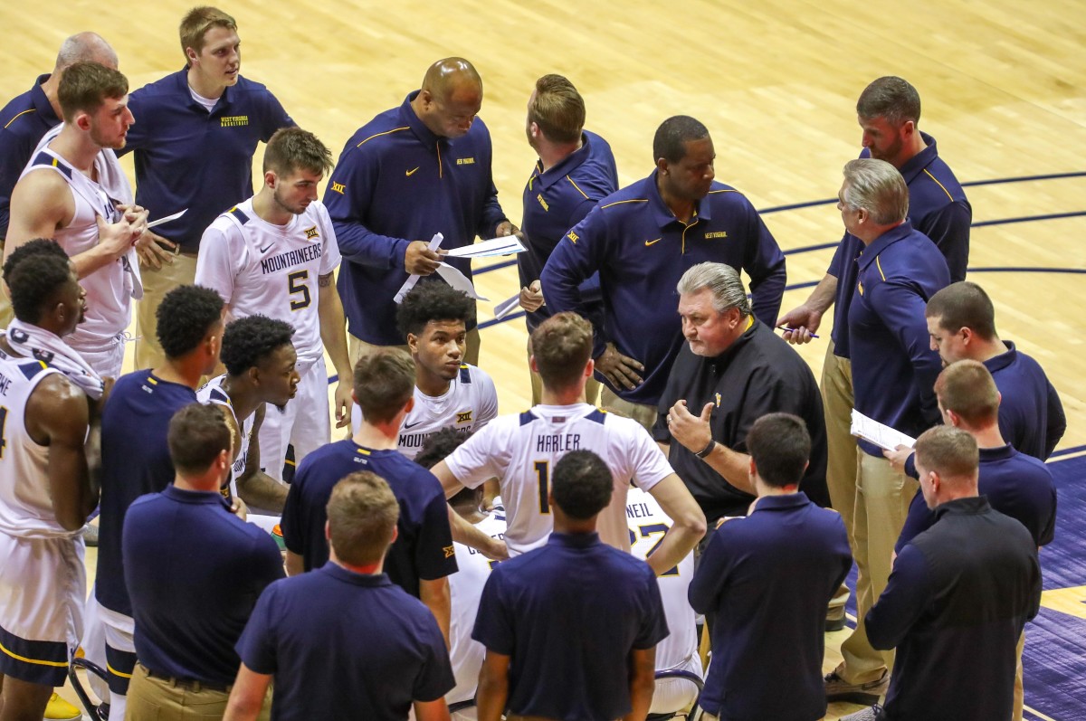 West Virginia Mountaineers head coach Bob Huggins talks with his team during a timeout during the first half against the Rhode Island Rams at WVU Coliseum.
