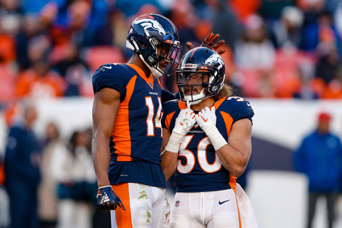 Denver Broncos wide receiver Courtland Sutton (14) with running back Phillip Lindsay (30) during a stoppage of play in the second quarter against the Los Angeles Chargers at Empower Field at Mile High.