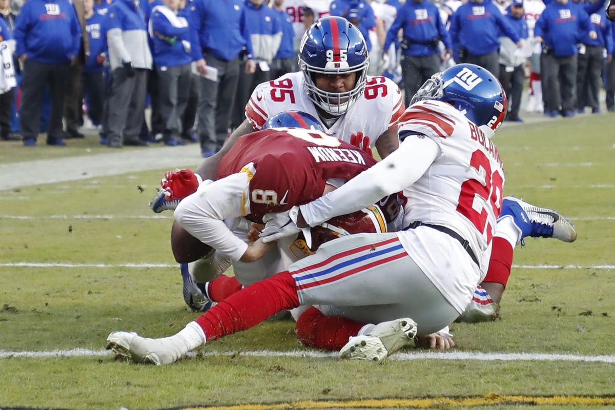 Dec 22, 2019; Landover, Maryland, USA; Washington Redskins quarterback Case Keenum (8) scores a touchdown as New York Giants defensive end B.J. Hill (95) and Giants outside linebacker Deone Bucannon (29) attempt the tackle in the fourth quarter at FedExField.