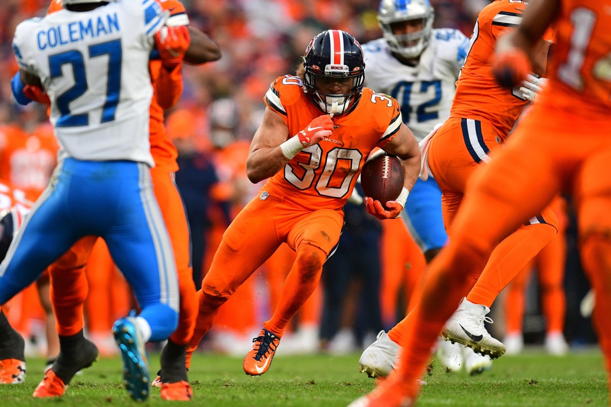 Denver Broncos running back Phillip Lindsay (30) carries the ball against the Detroit Lions in the third quarter at Empower Field at Mile High.