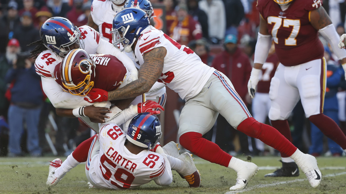 Redskins quarterback Dwayne Haskins is sacked during Sunday's game against the New York Giants.