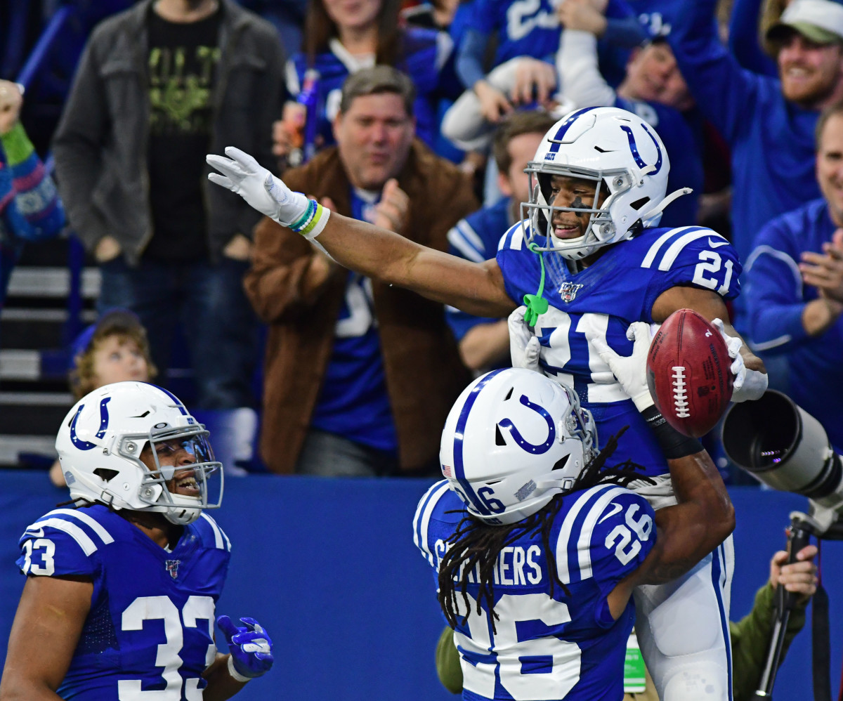 The Indianapolis Colts' Nyheim Hines (21) gets a lift from Clayton Geathers are returning a first-quarter punt 84 yards for a touchdown. Hines added a 71-yard TD punt return in the fourth quarter to become the first Colts player to have two scores on punt returns in franchise history.